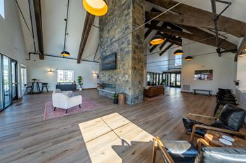 A living room with a stone pillar and wooden floors.