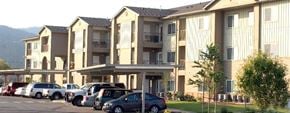 Post Falls apartment for rent - a row of cars parked in front of an apartment building