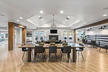 Spacious community room with coffered ceiling and fireplace