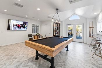 Recreation room with billiards table and bar seating