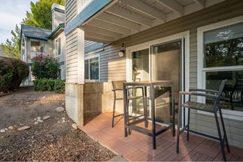 Private patio with outdoor dining furniture