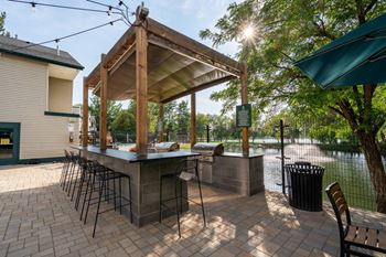 Outdoor barbecue pavilion with bar counter and stools