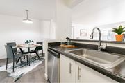 Boise apartment for rent - Modern kitchen with granite countertops and dining area at Edgewater Apartments, Boise, ID