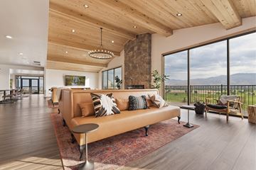 Boise apartment for rent - A modern living room with a large couch and a view of the mountains.