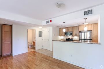 Cambridge apartment for rent - A kitchen with a wooden counter top and a microwave.