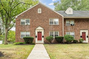 Rahway apartment for rent - A brick house with a red door and a white door.