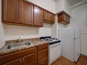 Troy apartment for rent - A kitchen with a white refrigerator and a white stove.