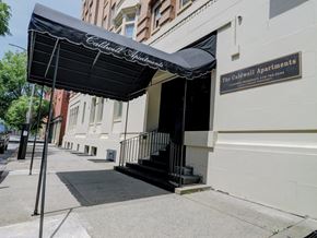 Troy apartment for rent - a building with a black awning on a sidewalk