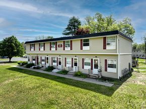 Gansevoort apartment for rent - the front of a white house with red shutters and a lawn