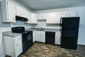 Schenectady apartment for rent - A kitchen with black and white appliances and cabinets.