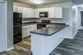 Cohoes apartment for rent - a kitchen with white cabinets and stainless steel counter tops