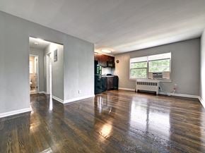 Wood-Ridge apartment for rent - an empty living room with a large window and a kitchen