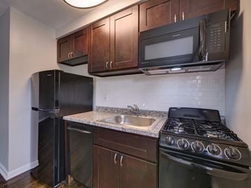 Wood-Ridge apartment for rent - a kitchen with a sink and a stove and a refrigerator
