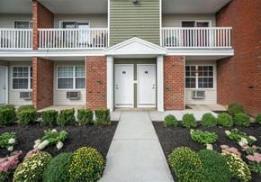 Cohoes apartment for rent - a walkway leading to a door in an apartment building