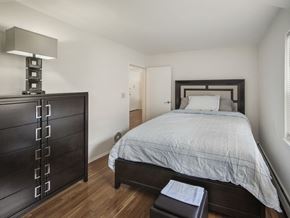 Rahway apartment for rent - A bedroom with a bed, nightstand, and a lamp.