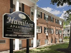 Rahway apartment for rent - A sign for Hamilton Apartments is in front of a brick building.