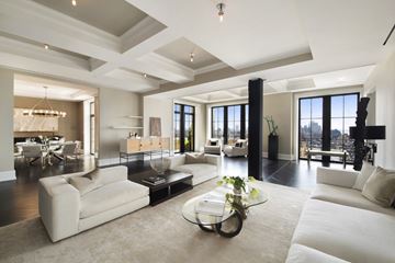Wake Forest apartment for rent - A modern living room with a glass coffee table and white couches.