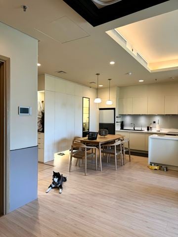 Chapel Hill apartment for rent - A dog is sitting on the floor in a kitchen.