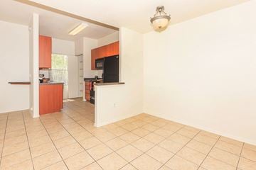 Mesa apartment for rent - A kitchen area with a refrigerator, microwave, and oven.