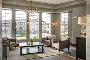 Glendale apartment for rent - A living room with a large window and a view of a pool and houses.