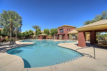 Tolleson apartment for rent - A large swimming pool with a building in the background.