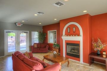 Glendale apartment for rent - A living room with a red couch and a fireplace.