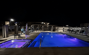 Prescott Valley apartment for rent - a swimming pool at night with a blue glow in it