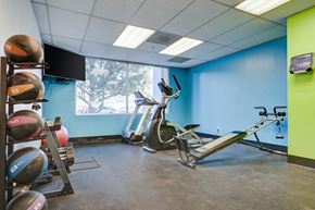 Birmingham apartment for rent - a gym with exercise equipment and a window
