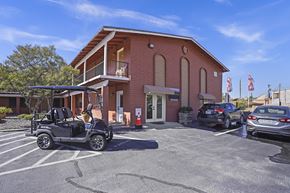 El Paso apartment for rent - a parking lot in front of a brick building with cars parked outside