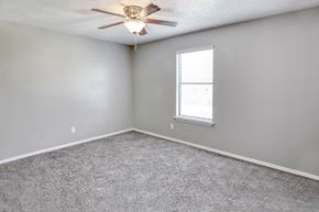 Kansas City apartment for rent - an empty room with a ceiling fan and a window