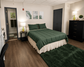 Birmingham apartment for rent - A bedroom with a bed, nightstand, and chair.