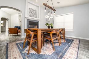 Las Cruces apartment for rent - a dining room with a wooden table and chairs in front of a fireplace