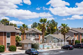 Las Cruces apartment for rent - an apartment building with a pool and cars parked in a parking lot