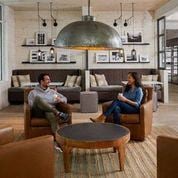 Amityville apartment for rent - two people sitting in a living room with couches and a table