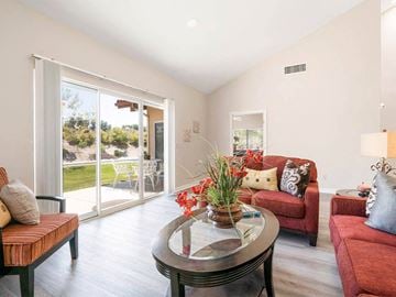 Riverside triplex for rent - A living room with a glass table and red couches.