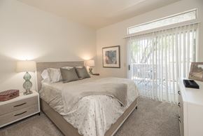 Roseville apartment for rent - A bedroom with a large bed and a window with blinds at Autumn Oaks Apartments, Roseville, CA, 95678