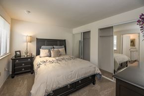 Rancho Cordova apartment for rent - A bedroom with a large bed and a dresser at Bishop's Court Apartments, California, 95670
