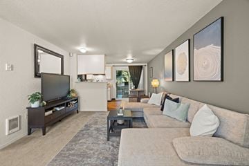 Portland apartment for rent - A living room with a grey couch and a television.