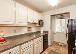 Beaverton apartment for rent - Model kitchen and laundry at King's Court Apartments, Beaverton, OR