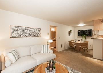 Beaverton apartment for rent - A living room with a white couch and a painting on the wall.