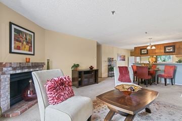 Kent apartment for rent - a living room with a fireplace and a table with chairs