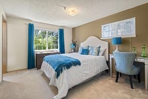 Kent apartment for rent - Model primary bedroom and furniture at Riverwood Apartments, Kent, Washington 98032