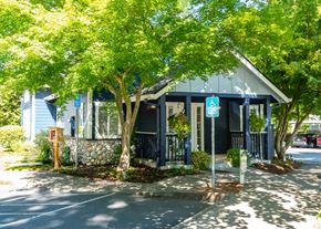 Hillsboro apartment for rent - Stillwater apartments leasing office entryway and parking lot