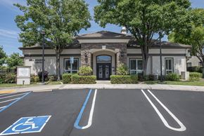 Roseville apartment for rent - A clubhouse with a parking lot in front of it at Stoneridge Apartments, California, 95661