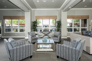 Roseville apartment for rent - a living room with couches and chairs and a table