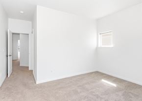 Oregon City townhouse for rent - A spacious, empty room with a carpeted floor and a small window at The Landing Apartments and Townhomes, Oregon, 97045