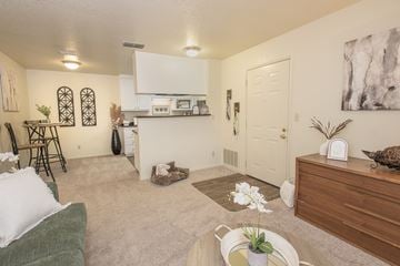 Rancho Cordova apartment for rent - A living room with a green couch and a white wall.