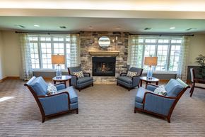 Winneconne apartment for rent - A living room with a fireplace and four chairs.