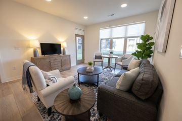 Menomonee Falls townhouse for rent - a living room with a couch and a table and a tv