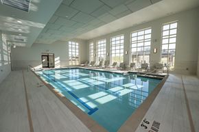 Menomonee Falls townhouse for rent - A view of an indoor pool with windows looking to the outside.